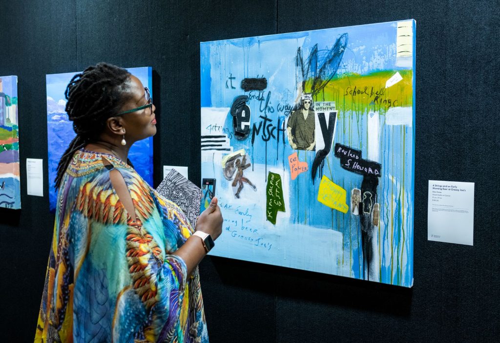 Recovered futures art exhibit hero - lady infront of a painting